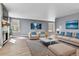 Bright living room features wood-look tile floors, a modern fireplace, and stylish furnishings at 8050 Bryant St, Westminster, CO 80031