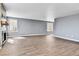 Bright living room features wood-look tile floors, a fireplace, and ample natural light at 8050 Bryant St, Westminster, CO 80031