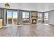 Spacious living room with wood-look tile floors, a fireplace, and natural light at 8050 Bryant St, Westminster, CO 80031