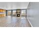 Living room featuring wood-look tile floors, a fireplace, and sliding glass doors at 8050 Bryant St, Westminster, CO 80031