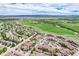 Aerial view of a residential area with a lake, green fields, and apartment complexes at 10056 W Unser Dr # 106, Littleton, CO 80127