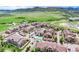 An aerial view shows the community with a pool and lush green surroundings, nestled against a backdrop of rolling mountains at 10056 W Unser Dr # 106, Littleton, CO 80127