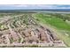 Breathtaking aerial view of the community, highlighting homes, green spaces, and a lake at 10056 W Unser Dr # 106, Littleton, CO 80127