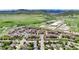 Scenic aerial view of apartment community with pool and surrounding green space and mountain backdrop at 10056 W Unser Dr # 106, Littleton, CO 80127