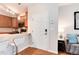 Bright entryway with hardwood floors, modern kitchen view, and living room details at 10056 W Unser Dr # 106, Littleton, CO 80127