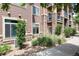 Exterior view of a brown apartment building with stone accents and landscaping at 10056 W Unser Dr # 106, Littleton, CO 80127