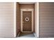 Inviting brown front door with a decorative wreath and unit number 106 at 10056 W Unser Dr # 106, Littleton, CO 80127