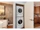 Convenient laundry area featuring a stacked washer and dryer inside of a closet at 10056 W Unser Dr # 106, Littleton, CO 80127