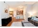Spacious living room with open layout, modern decor, and bar-style seating area at 10056 W Unser Dr # 106, Littleton, CO 80127
