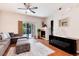 Bright living room with a fireplace, modern furniture, and access to outdoor space at 10056 W Unser Dr # 106, Littleton, CO 80127