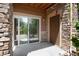 Exterior patio with a sliding glass door and a front door to enter the home at 10056 W Unser Dr # 106, Littleton, CO 80127