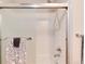 Tiled shower with sliding glass door and a showerhead at 10056 W Unser Dr # 106, Littleton, CO 80127