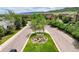 Street view featuring the community entrance sign and tree-lined streets at 10056 W Unser Dr # 106, Littleton, CO 80127
