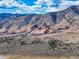 A far aerial view of the mountains, hills, and Red Rocks Amphitheatre at 2363 S Lupine Way, Denver, CO 80228