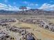 An aerial view of the neighborhood and surrounding area with Red Rocks Amphitheater in the distance at 2363 S Lupine Way, Denver, CO 80228
