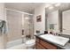 Bathroom with tiled shower, single sink, and dark countertop at 2363 S Lupine Way, Denver, CO 80228