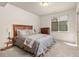 Bedroom with window and neutral tones, featuring a wood-framed bed and dark dresser at 2363 S Lupine Way, Denver, CO 80228