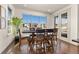 Sunlit dining area featuring hardwood floors, large windows, and views of the community at 2363 S Lupine Way, Denver, CO 80228