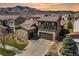Beautiful two-story home featuring a covered porch, a two-car garage, and mountain views at 2363 S Lupine Way, Denver, CO 80228