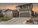 Charming two-story home features a covered porch, two-car garage and manicured landscaping at 2363 S Lupine Way, Denver, CO 80228