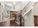 Elegant staircase with iron railings and open-concept living space with stone fireplace at 2363 S Lupine Way, Denver, CO 80228