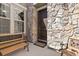 Inviting stone porch with seating and a decorative front door at 2363 S Lupine Way, Denver, CO 80228