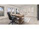Home office space featuring carpet floors, large desk, French doors, and views of the outdoors at 2363 S Lupine Way, Denver, CO 80228