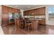Gourmet kitchen with custom cabinets, stainless steel appliances, and a center island with bar seating at 2363 S Lupine Way, Denver, CO 80228