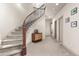 Stylish staircase featuring a curved design, iron railings, and carpeted steps at 2363 S Lupine Way, Denver, CO 80228