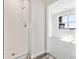 Bathroom featuring a shower and view into bedroom with large bright window at 6840 Merseyside Ln, Castle Pines, CO 80108