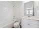 Bright bathroom featuring a shower-over-tub, white cabinets, and modern fixtures at 6840 Merseyside Ln, Castle Pines, CO 80108