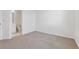 Carpeted bedroom conveniently located near an ensuite bathroom at 6840 Merseyside Ln, Castle Pines, CO 80108