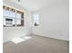 Bright bedroom featuring large windows with natural light and neutral carpeting at 6840 Merseyside Ln, Castle Pines, CO 80108