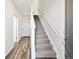 Inviting entryway with hardwood floors, carpeted stairs, and natural light at 6840 Merseyside Ln, Castle Pines, CO 80108