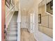 Bright hallway featuring stairs, light wood floors, neutral walls, and decorative mirror at 6840 Merseyside Ln, Castle Pines, CO 80108