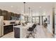 Open concept kitchen with island seating, stainless appliances, and modern finishes in the great room at 6840 Merseyside Ln, Castle Pines, CO 80108