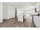Bright kitchen with an island, stainless steel dishwasher, and hardwood floors at 6840 Merseyside Ln, Castle Pines, CO 80108