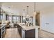 Stylish kitchen with an island, pendant lighting and seamless flow to the living area at 6840 Merseyside Ln, Castle Pines, CO 80108