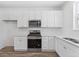 Contemporary kitchen features stainless appliances and white cabinetry at 6840 Merseyside Ln, Castle Pines, CO 80108