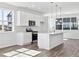 Modern kitchen with white cabinets, stainless steel appliances, and a stylish island at 6840 Merseyside Ln, Castle Pines, CO 80108