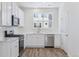 Bright kitchen features stainless appliances and white cabinets at 6840 Merseyside Ln, Castle Pines, CO 80108