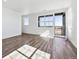 Living room with hardwood floors, bright windows, and an open patio at 6840 Merseyside Ln, Castle Pines, CO 80108