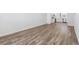 Expansive living room featuring wood-look floors, flowing naturally into other living spaces at 6840 Merseyside Ln, Castle Pines, CO 80108
