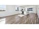 Sunlit living space showcasing wood floors and large windows with neighborhood views at 6840 Merseyside Ln, Castle Pines, CO 80108