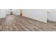 Bright living room with durable wood-look floors and ample natural light at 6840 Merseyside Ln, Castle Pines, CO 80108