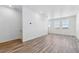 Large living room with wood flooring and scenic views at 6840 Merseyside Ln, Castle Pines, CO 80108