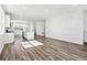 Bright, open-concept living space featuring wood floors and a modern kitchen island at 6840 Merseyside Ln, Castle Pines, CO 80108