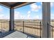 Scenic patio with black metal fence overlooking beautiful mountain views at 6840 Merseyside Ln, Castle Pines, CO 80108