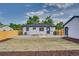 A backyard featuring a new fence, gravel bed and a yard with new lawn squares at 2701 Barnhart St, Thornton, CO 80229