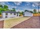 Spacious backyard featuring a detached garage, privacy fence, and newly landscaped lawn at 2701 Barnhart St, Thornton, CO 80229